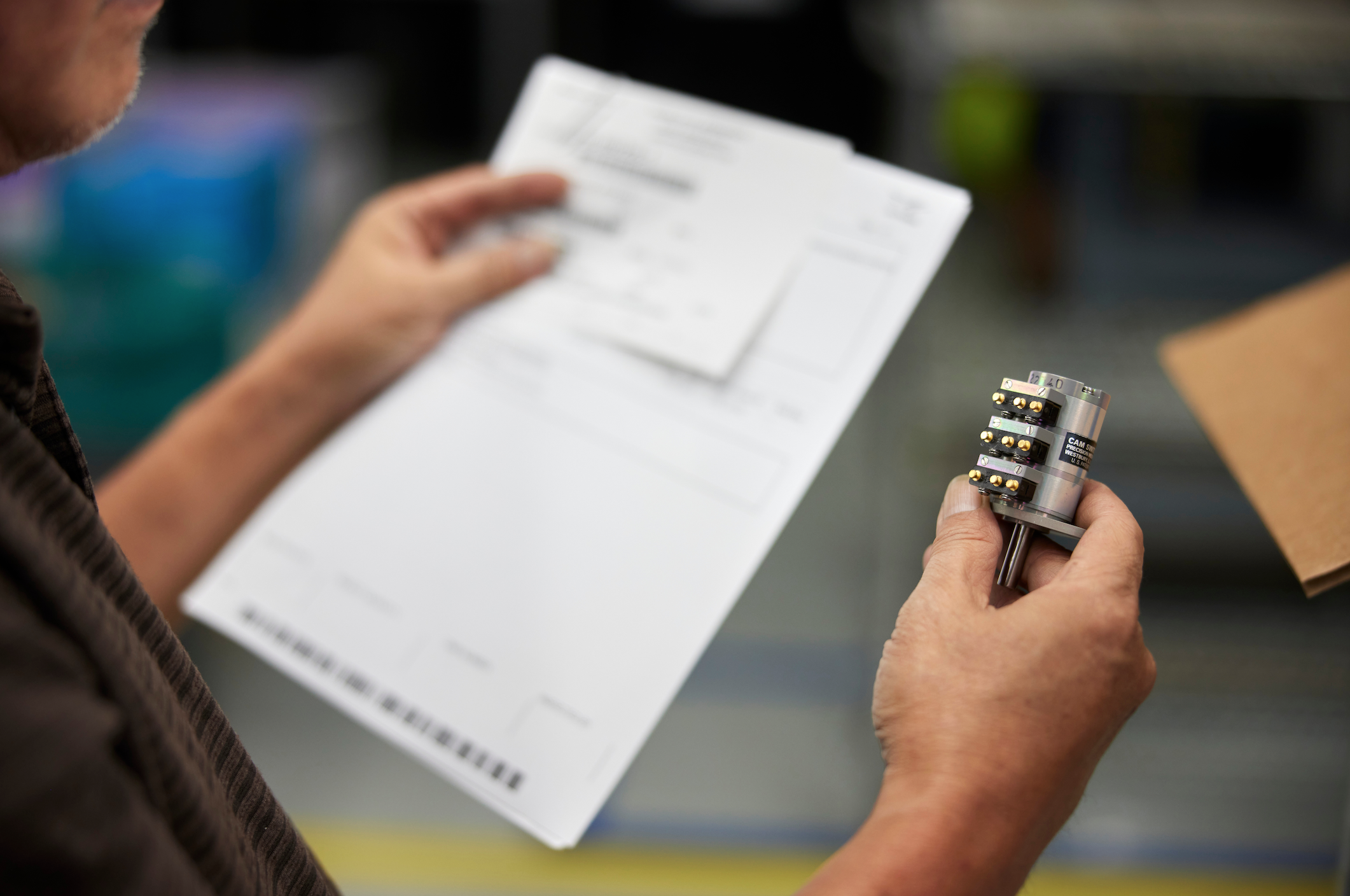 detailed-view-of-person-holding-up-document-and-aircraft-component